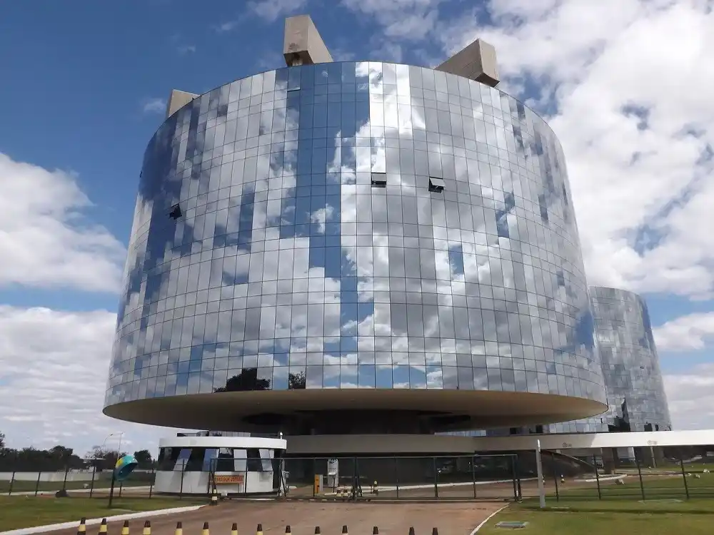 Modernist government building in Brasilia reflecting the blue sky.