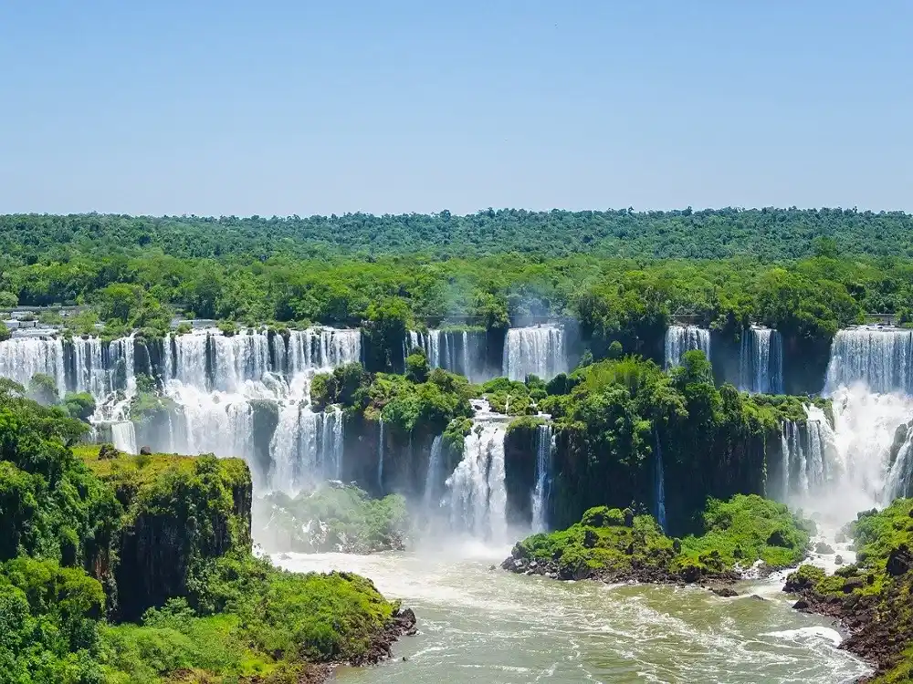 Iguazu Falls surrounded by lush rainforest on the Brazil side.