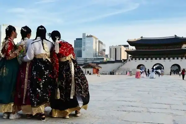 Visitors wearing traditional hanbok at Gyeongbokgung Palace in Seoul.