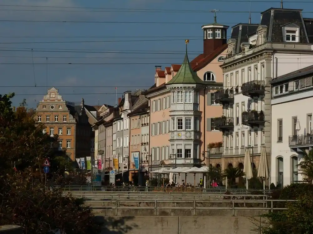 Colourful historic buildings and cafés along a street in Konstanz.
