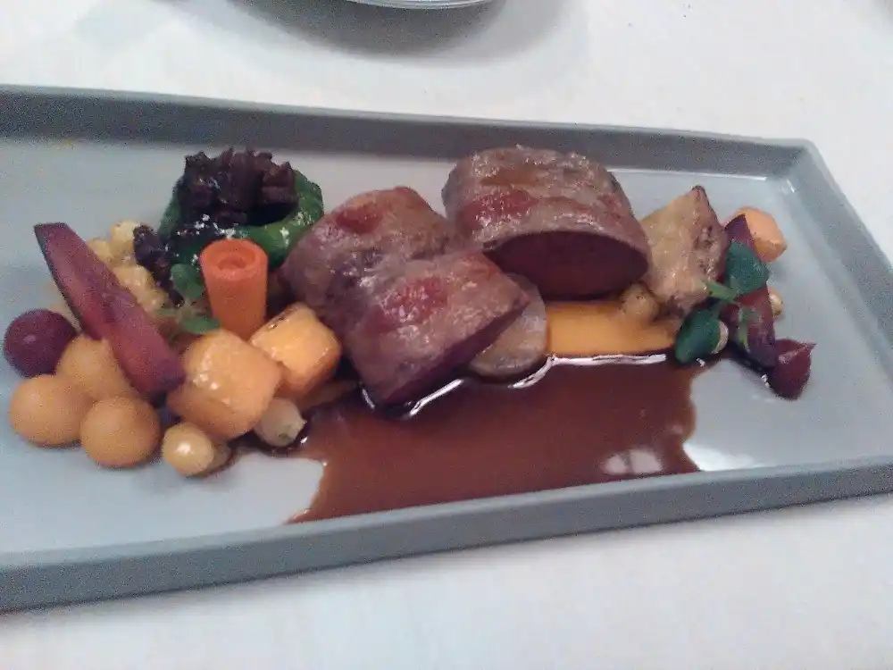 Fine dining dish with meat, vegetables and sauce at the two-Michelin-star restaurant Ophelia in Konstanz.