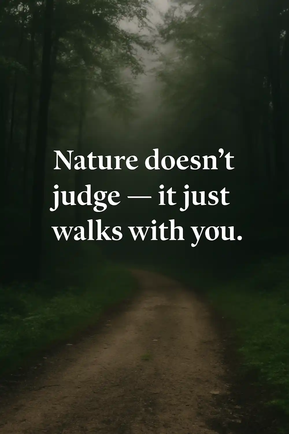 Inspirational quote “Nature doesn’t judge, it just walks with you” over a misty forest path surrounded by trees.
