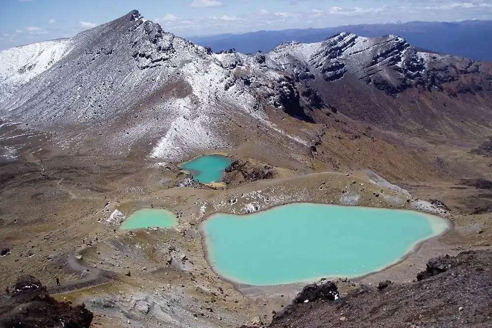 Turquoise Emerald Lakes surrounded by volcanic mountains and rocky terrain in Tongariro National Park, New Zealand.