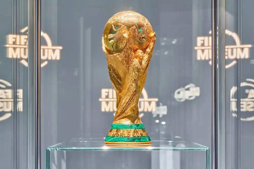 The FIFA World Cup Trophy displayed inside a glass case at the FIFA World Football Museum in Zurich.