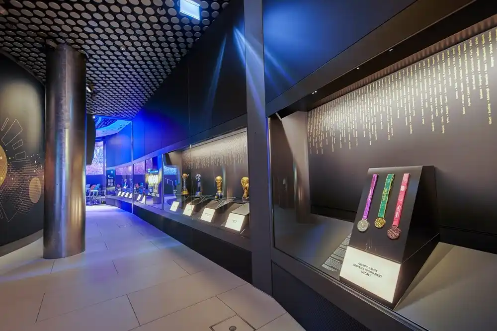 World Cup Gallery exhibition corridor inside the FIFA World Football Museum in Zurich featuring trophies and football memorabilia.
