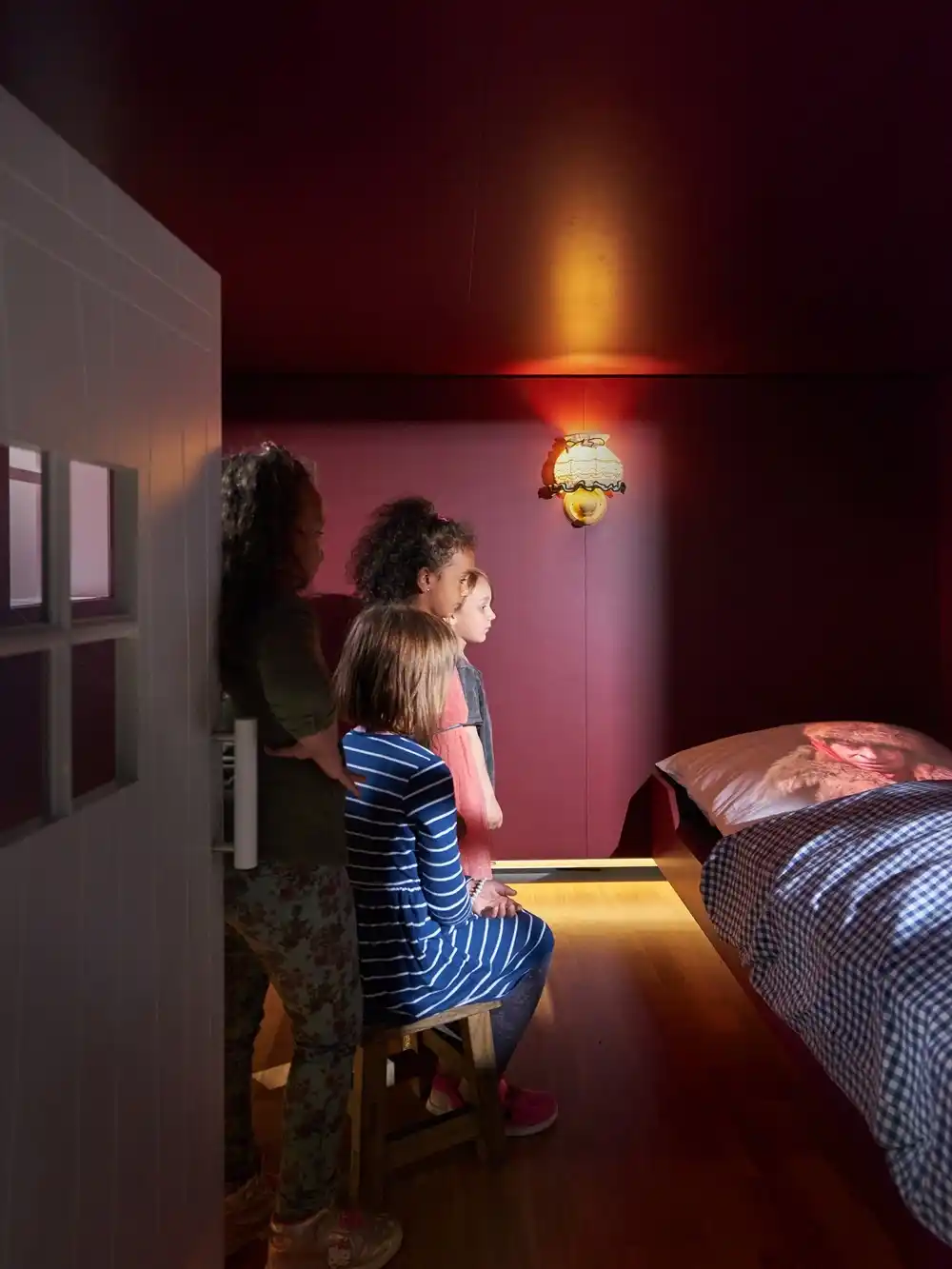 Little Red Riding Hood scene at GRIMMWELT Kassel with children viewing wolf in grandmother’s bed Germany.